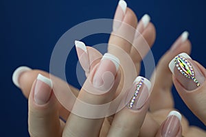 Female hands with beautiful french manicure with decotations. photo