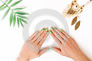 Female hands with beautiful stylish green manicure.