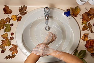 Female hands being disinfected with water and soap