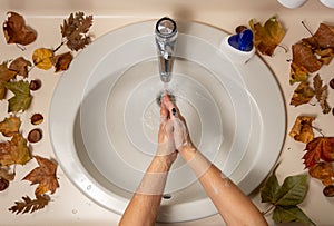 Female hands being disinfected with water and soap