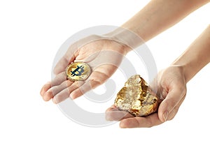 Female hands with bitcoin and gold nugget on white background