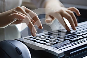 Female hands on the black keyboard.
