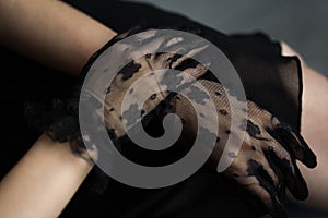 Female hands in black lace gloves