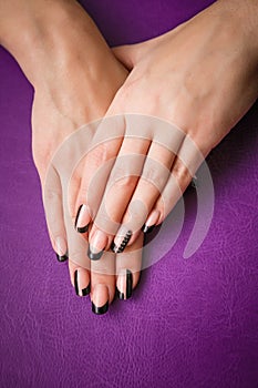 Female hands with black manicure