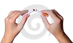 Female hands breaking a cigarette in two isolated on white