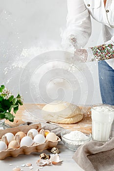 Female Hands Clapping Making Flour Splash above the Dough