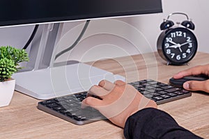 Female hands on computer keyboard and mouse. Working or studying on computer