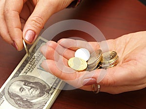 Female hands consider coins