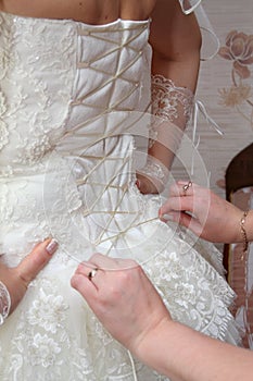 Female hands corset bride