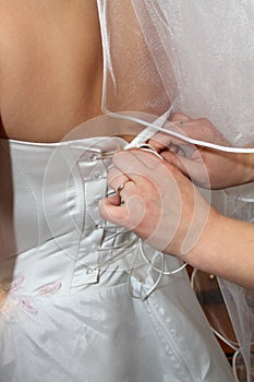 Female hands corset bride