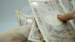 Female hands counting japan money banknotes