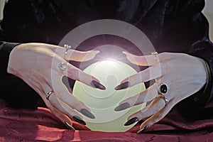 Female hands with a crystal ball. Forecasting the future, clairvoyance