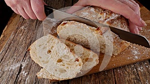 Female hands cut appetizing bread