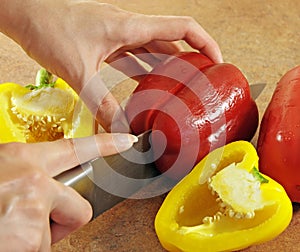 Female hands cut pepper