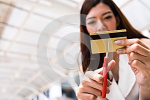 Female hands cutting credit card with scissors.