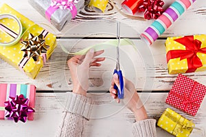 Female hands cutting a ribbon