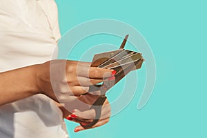 Female hands are cutting a stack of credit cards with scissors