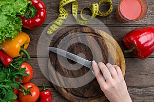 Female hands cutting vegetables at table, top view