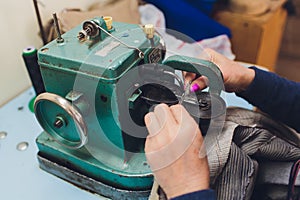 Female hands doing maintenance work on a domestic sewing machine.