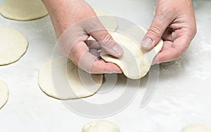 In female hands dough for pies photo