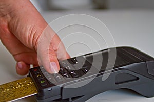 Female hands entering credit card PIN for password security in terminal