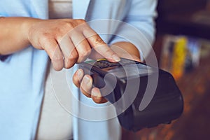 Female hands entering PIN number