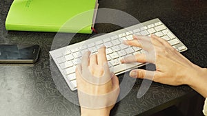 Female hands fast typing on the keyboard