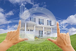 Female Hands Framing House Drawing and House Above Grass