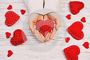 Female hands giving red heart. Valentine day background toned, vintage