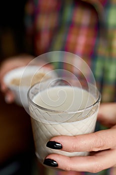 Female hands with glasse of vegan milk, Alternative types of non-dairy milks