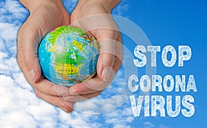 Female hands with globe, stop corona virus photo