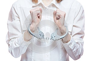 Female hands with handcuffs, on a white background