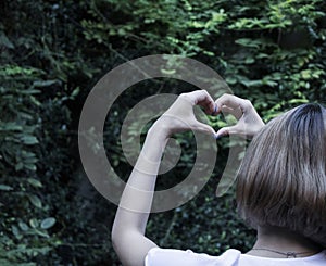 Female hands heart shape on isolated nature background