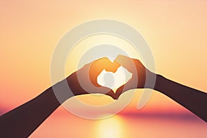 Female hands heart shape on sunset sky at tropical beach abstract background. Copy space of happy love travel and freedom in