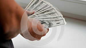 Female hands hold dollar bills in hand