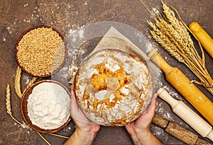 Female hands hold freshly baked bread