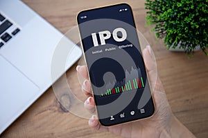 Female hands hold phone with IPO stocks purchase app