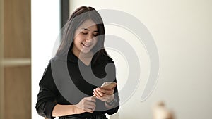 Female hands hold smart phone using for typing text message.