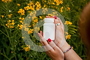 Female hands hold a white jar against