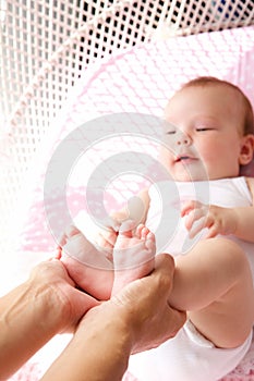 Female hands holding baby feet