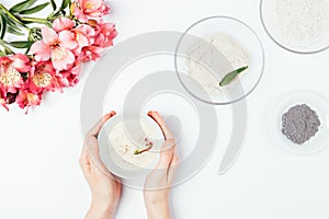 Female hands holding  bowl with homemade cosmetic clay face mask