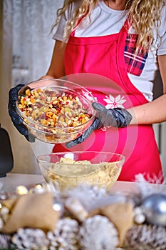 Female hands holding a bowl Ingredients nuts and raisins for cookies, Version 2