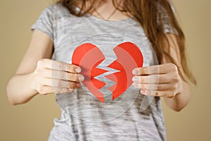 Female hands holding broken blank empty red Valentines card with