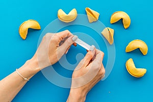 Female hands holding Chinese New Year fortune cookie. Good luck concept