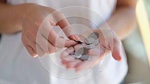 Female hands holding and counting silver coins