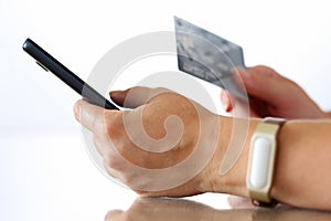 Female hands holding credit card and making online purchase usin