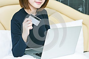 Female hands holding credit card and using laptop. Online shopping