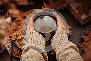 Female hands holding cup of coffee