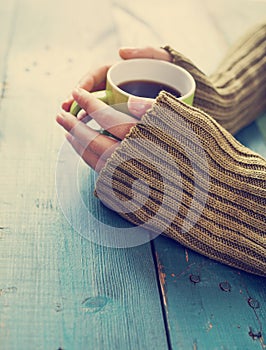 Female hands holding cup of coffee