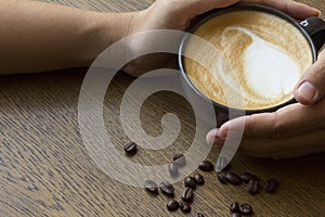 Female hands holding cups of coffee